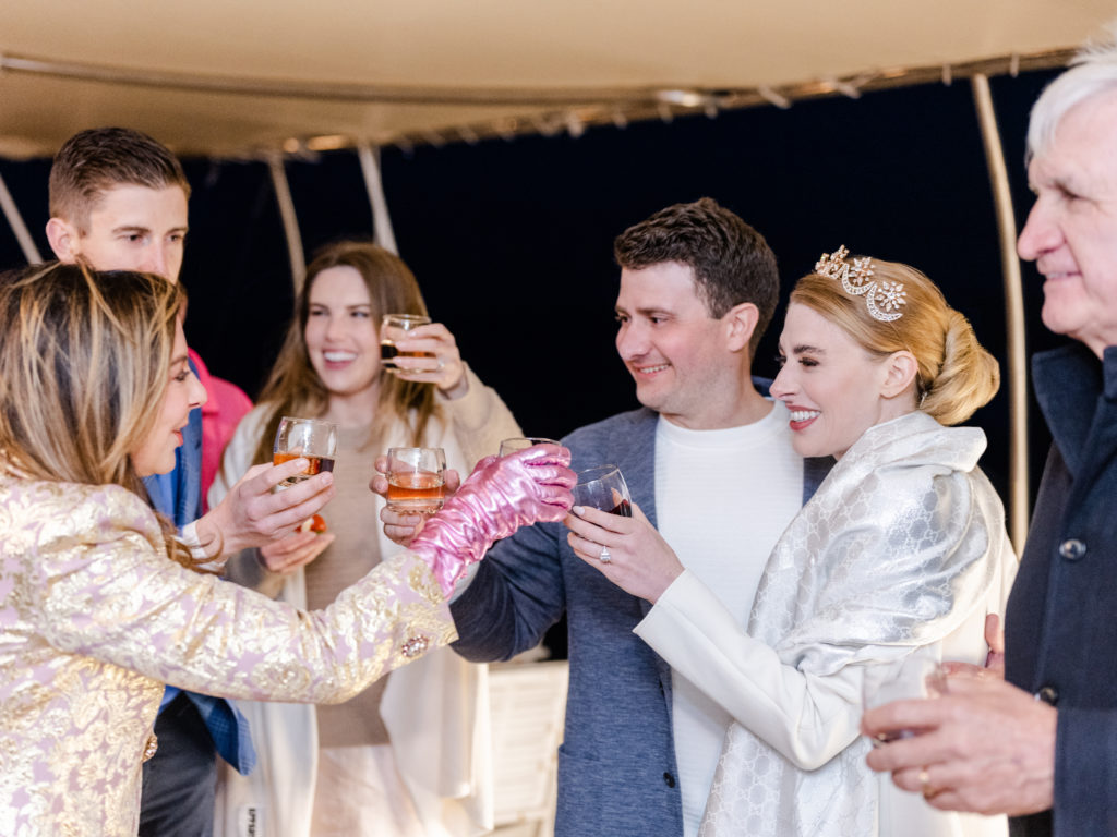 Couples toast on a sailboat in the Mediterranean. 
