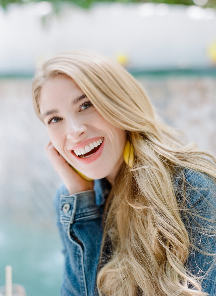 Sarah Kay Love smiling with lemon earrings