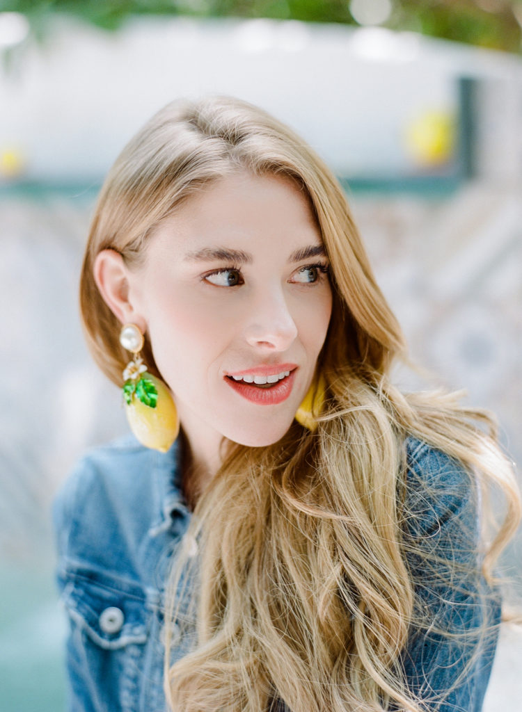 Sarah Kay Love headshot with lemon earrings