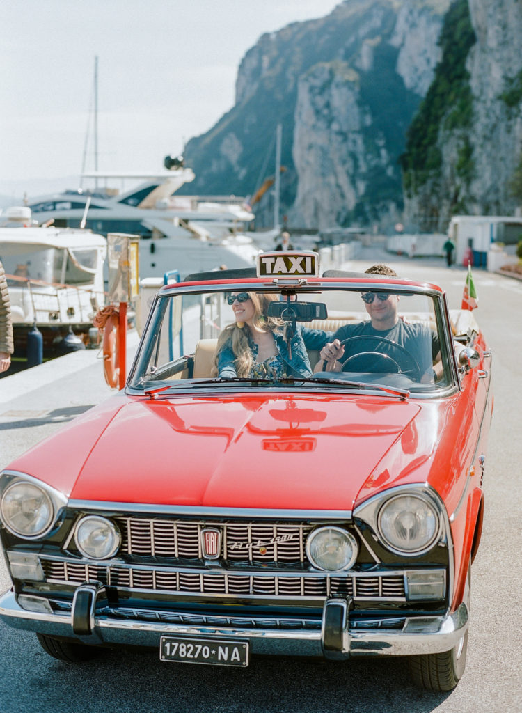 Couple driving a Fiat 1500 on Capri