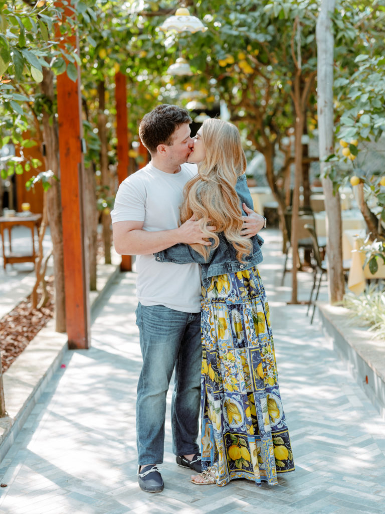 Couple kissing at Da Paulino Restaurant under the lemon trees.