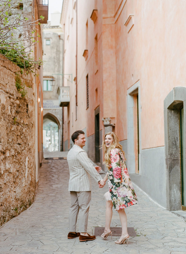 Nick and Sarah walking down a street near The Belmond Caruso, Italy. 