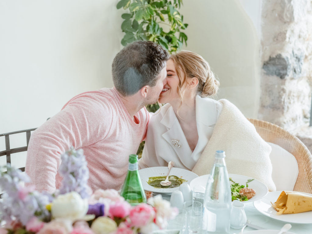 Couple kissing while at a brunch in Ravello, Italy