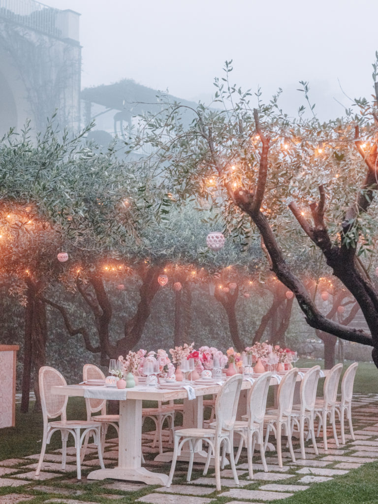 Melon-Themed Rehearsal Dinner under a canopy of trees with hanging lanterns 