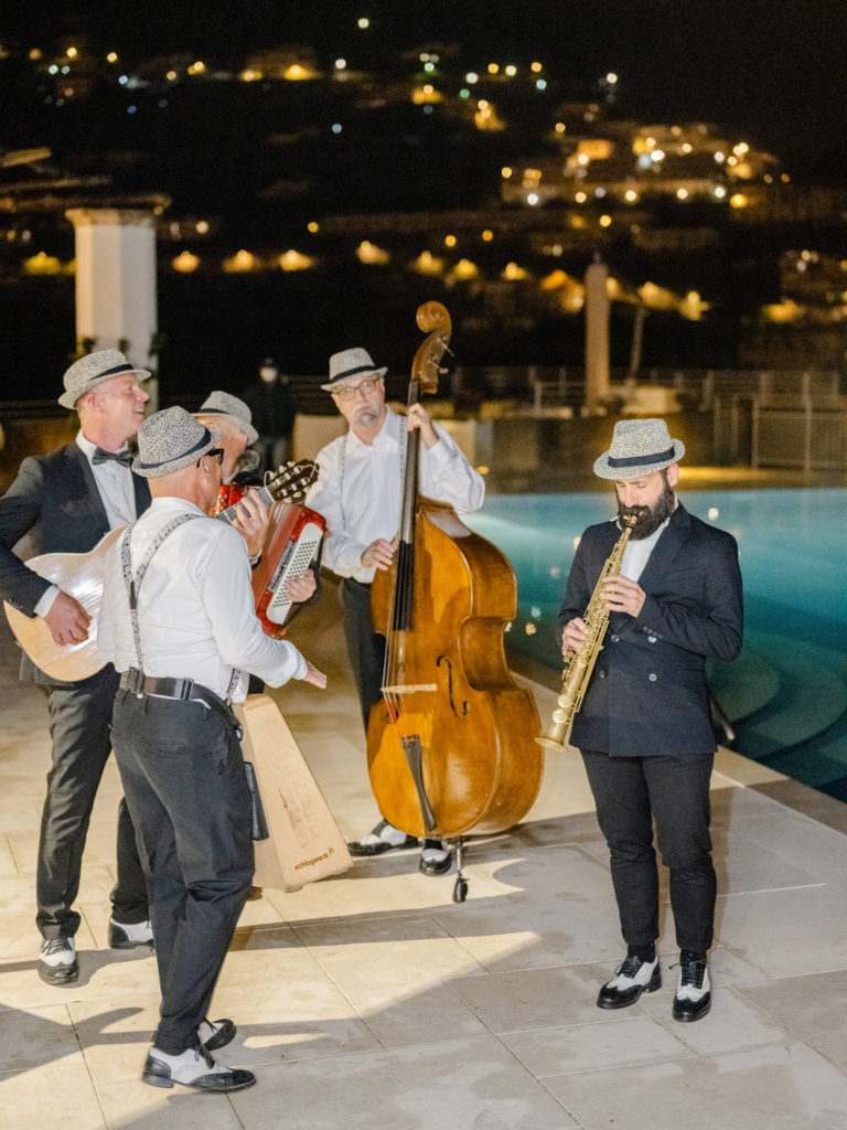 Musicians playing at a wedding rehearsal dinner at the Belmond Caruso