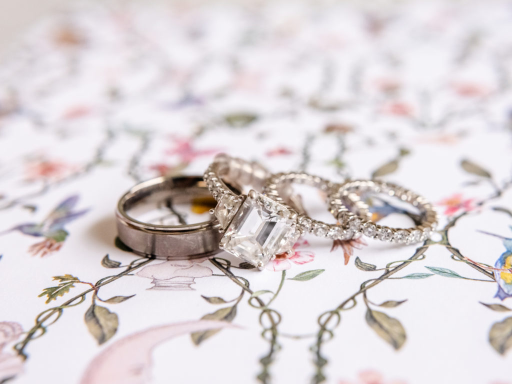 Wedding and engagement rings on a floral tablecloth
