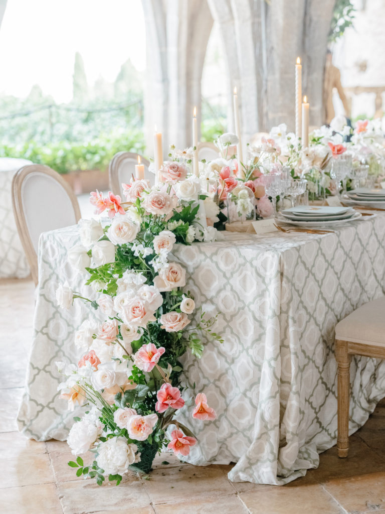Villa Cimbrone wedding reception table adorned with flowers and tall candlesticks