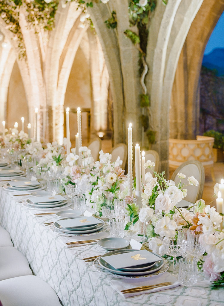 Villa Cimbrone wedding reception table under stone archway with flowers